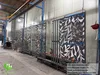 Large scale architectural laser-cut aluminum facade panels in factory workshop, 3.0mm thickness exterior wall decorative cladding.
